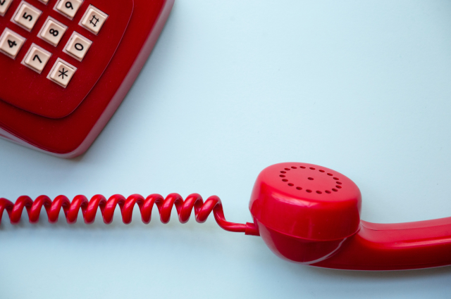 red telephone on blue background