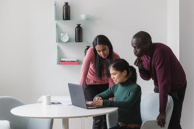 three people working on laptop