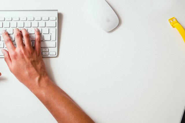 one hand typing on keyboard with mouse