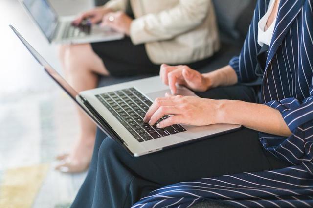 women sitting on chairs working on laptops