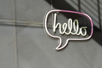 hello speech bubble on metal fence