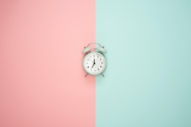 clock on blue and pink background