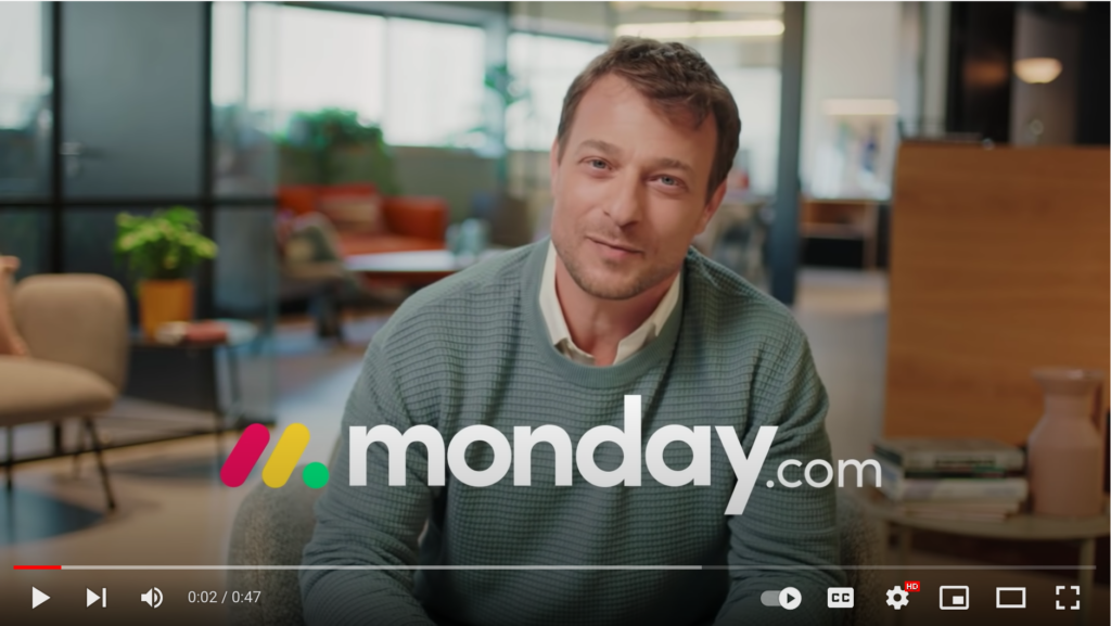 screenshot of Monday.com commercial video showing a business professional