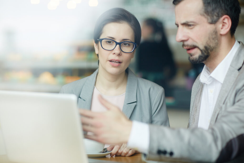 Two business people discussing results on a sales engagement platform