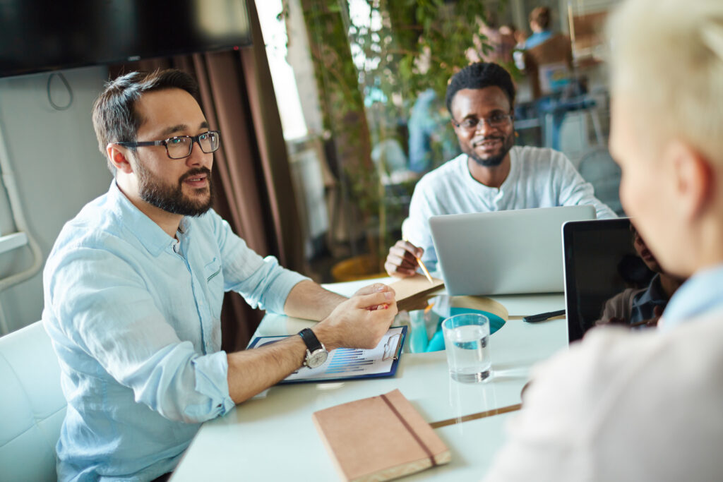 Group of co-workers discussing sales intelligence software