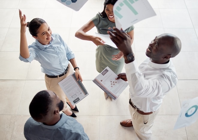 Team of professionals stands in a circle celebrating about SEO and lead tracking success