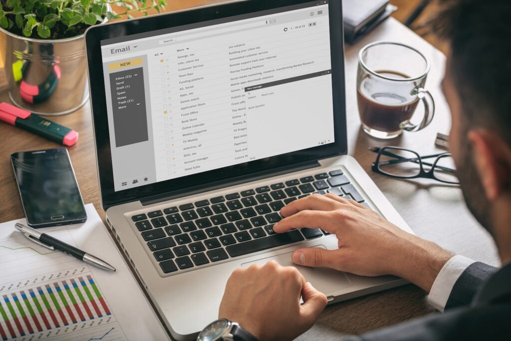 Silhouette of man's head looking at a laptop working on the B2B funnel follow-up