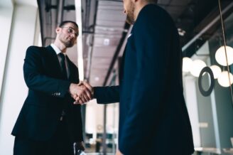two businessman shake hands at the close of a deal at the end of the B2B funnel